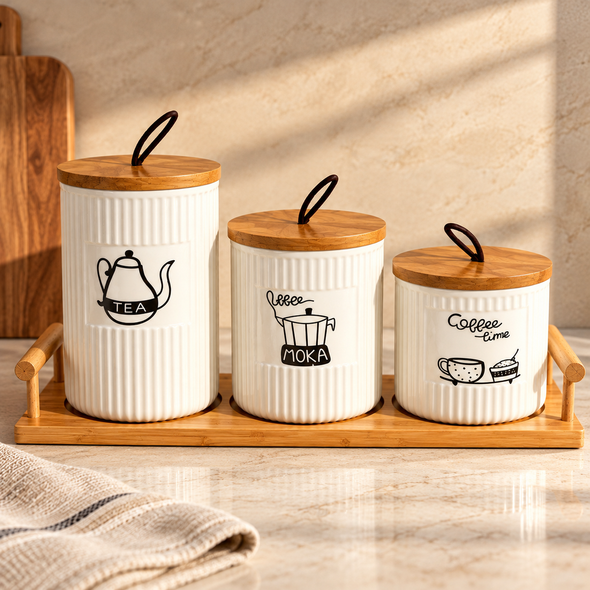Ceramic tea coffee canister set with wooden tray in kitchen countertop setting